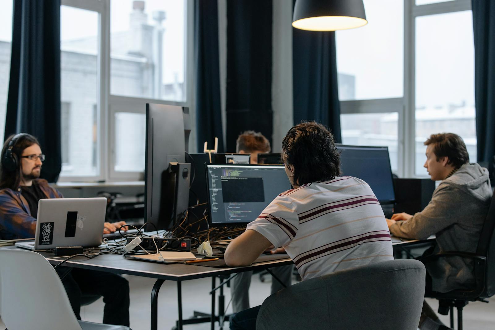 Developers working at computer desks during software implementation