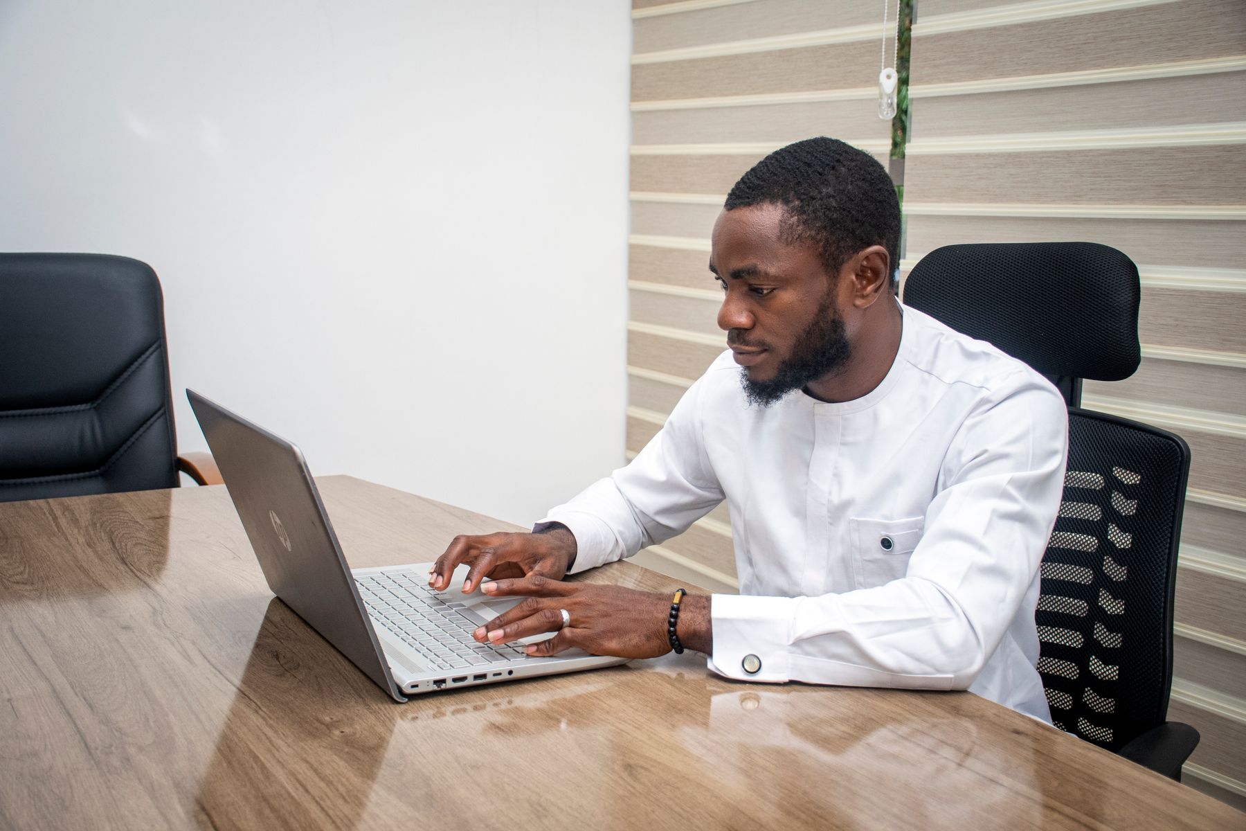 Professional consultant working on a laptop in an office